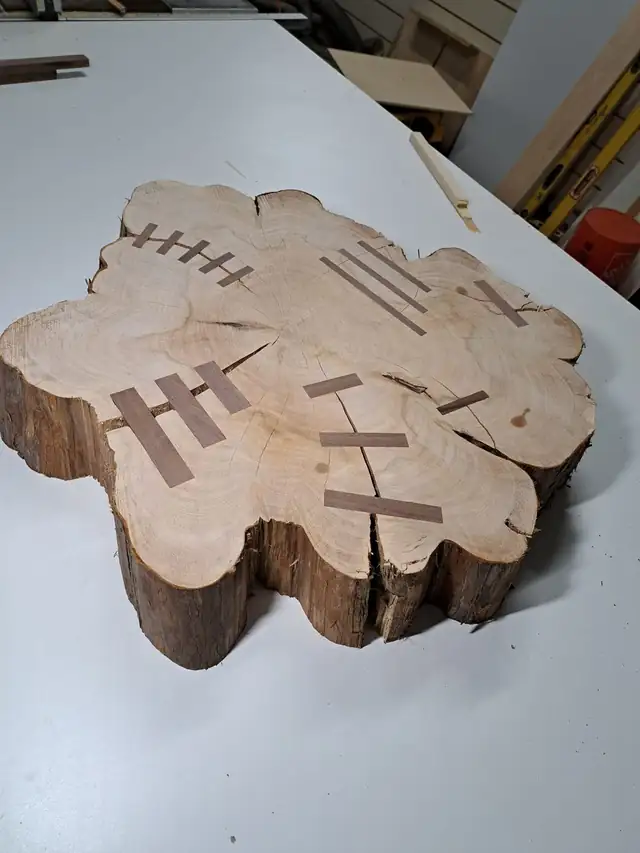 Cypress tree trunk cross cut with dark walnut bowtie inlays